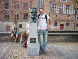 Tim with a bust of Frank van Acker at the Vismarkt square, and the Groenerei canal