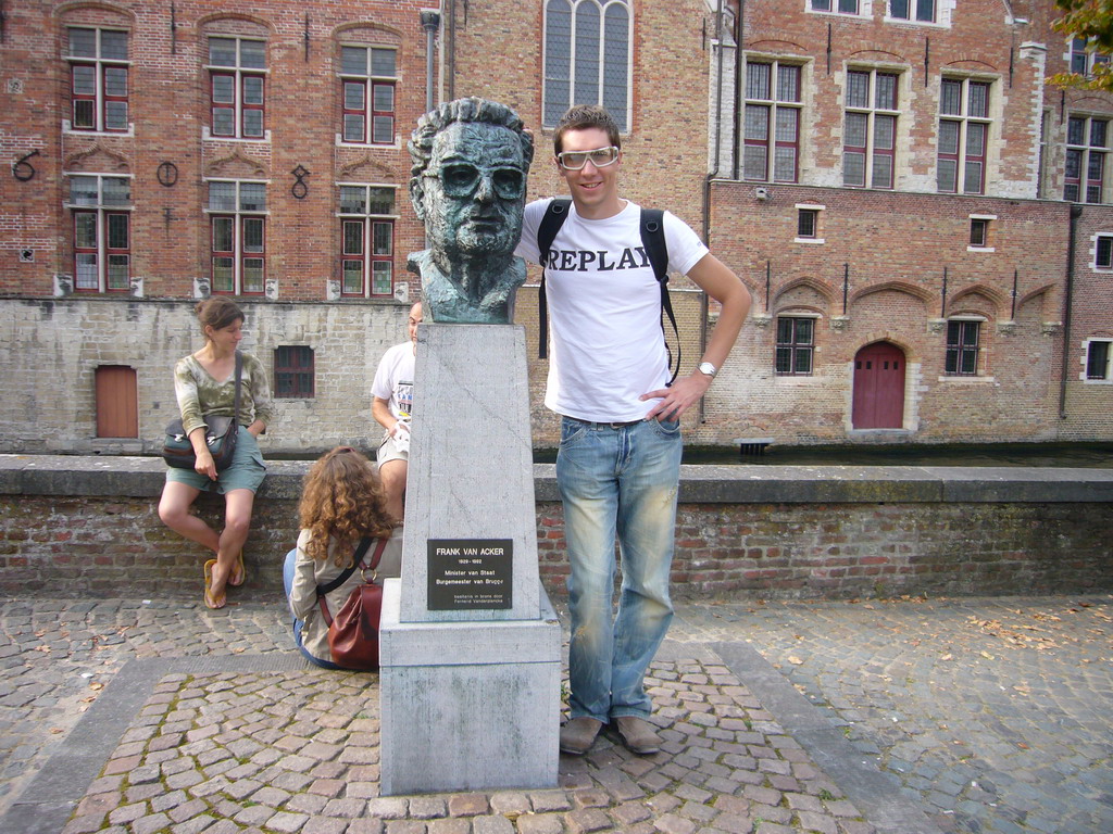 Tim with a bust of Frank van Acker at the Vismarkt square, and the Groenerei canal