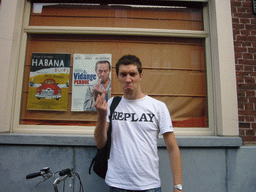 Tim in front of a poster in the city center