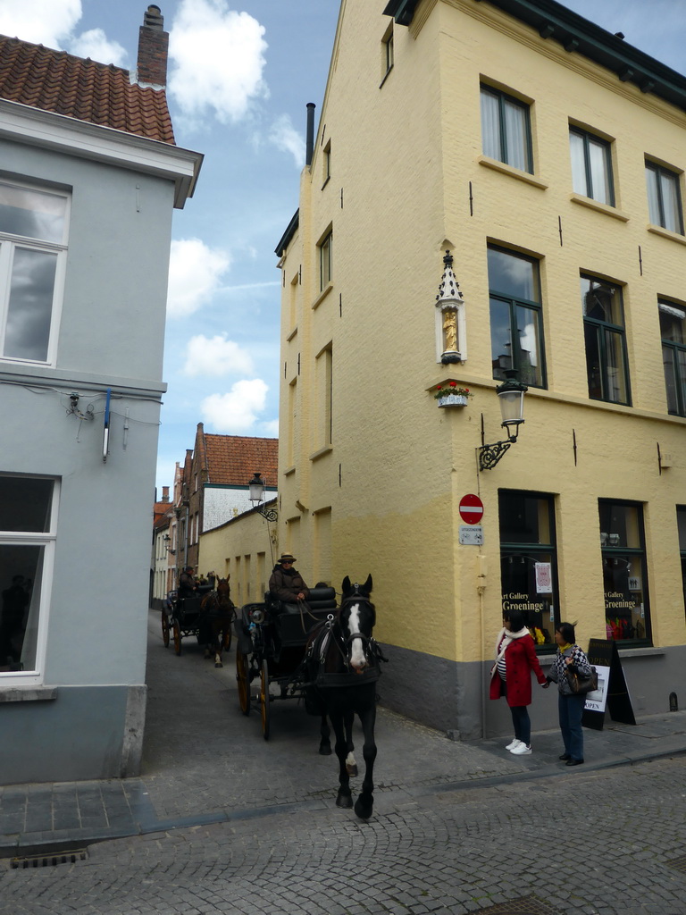 Miaomiao, Miaomiao`s mother and horses and carriages at the crossing of the Groeninge street and the Nieuwe Gentweg street