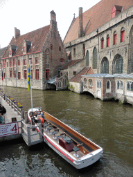 Boat at the west side of the Bakkersrei canal and the south side of the Oud Sint-Janshospitaal museum, viewed from the Mariastraat bridge