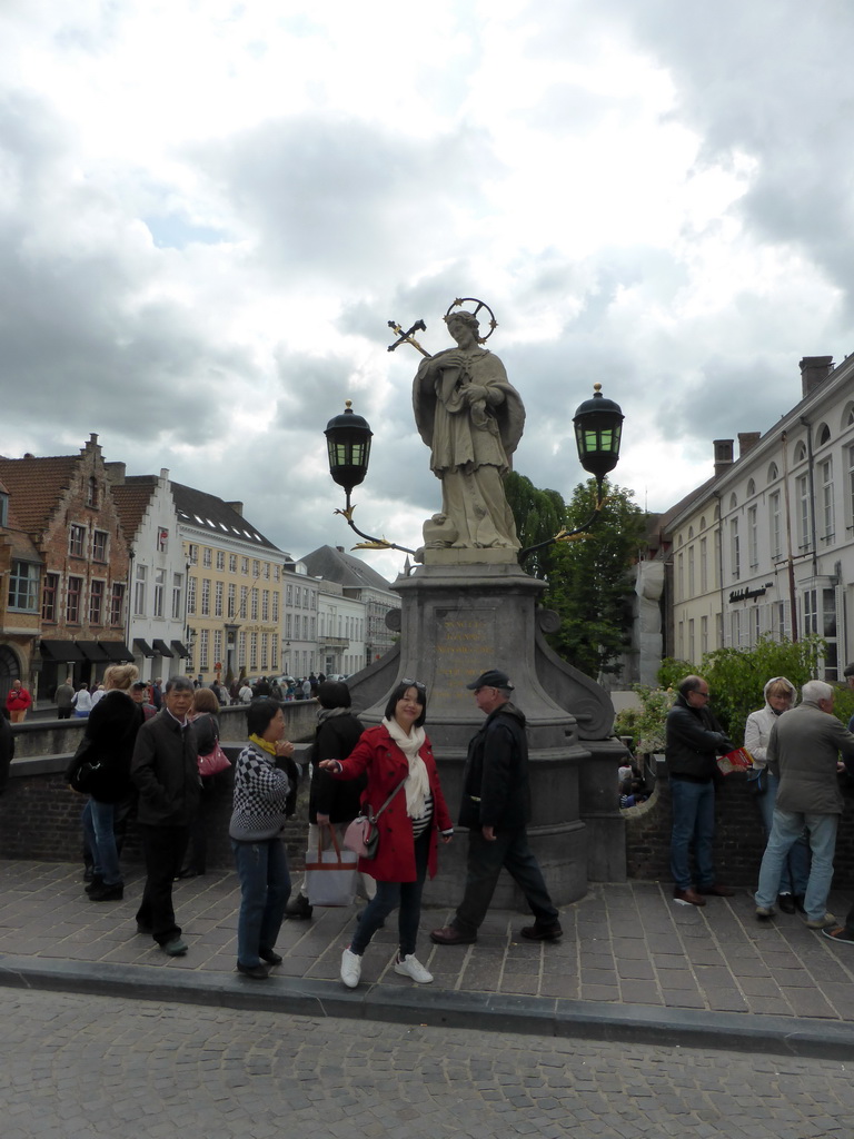 Miaomiao and her parents in front of the Statue of Saint John of Nepomuk, at the Nepomucenusbrug bridge over the Dijver canal