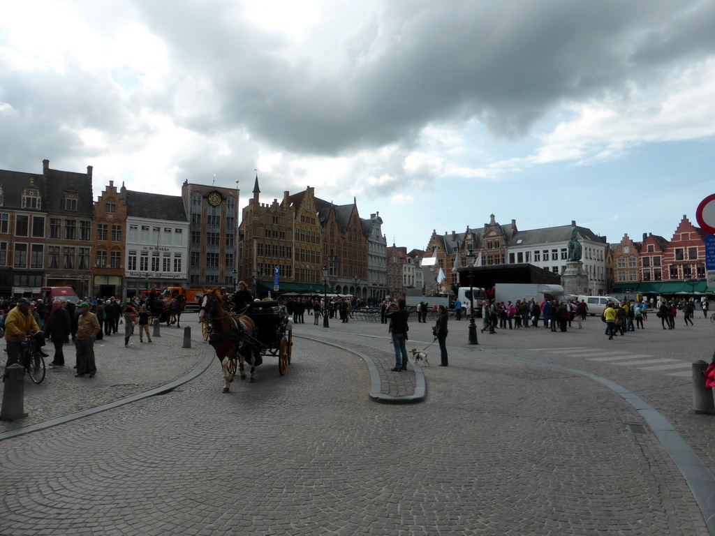The Markt square with a horse and carriage and the Statue of Jan Breydel and Pieter de Coninck