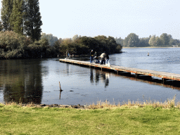 People catching crabs on a pier at the back side of the Paviljoen Meerzicht restaurant