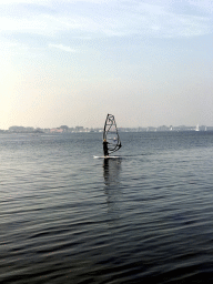 Surfer on the Grevelingenmeer lake, viewed from a pier at the northwest side of the Grevelingendam