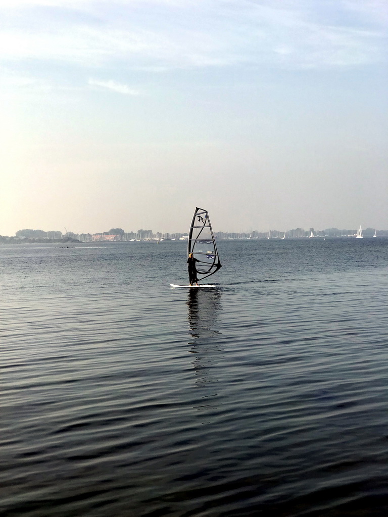 Surfer on the Grevelingenmeer lake, viewed from a pier at the northwest side of the Grevelingendam