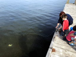 Miaomiao and Max catching crabs on a pier at the northwest side of the Grevelingendam