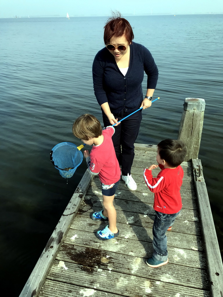 Miaomiao and Max catching crabs on a pier at the northwest side of the Grevelingendam