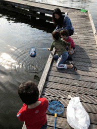 Max and people catching crabs on a pier at the northwest side of the Grevelingendam