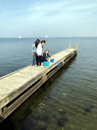 Miaomiao and other people catching crabs on a pier at the northwest side of the Grevelingendam