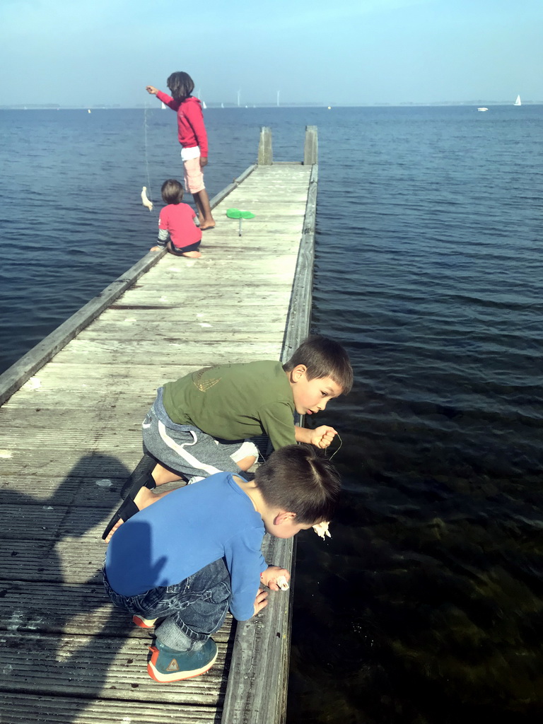 Max and people catching crabs on a pier at the northwest side of the Grevelingendam