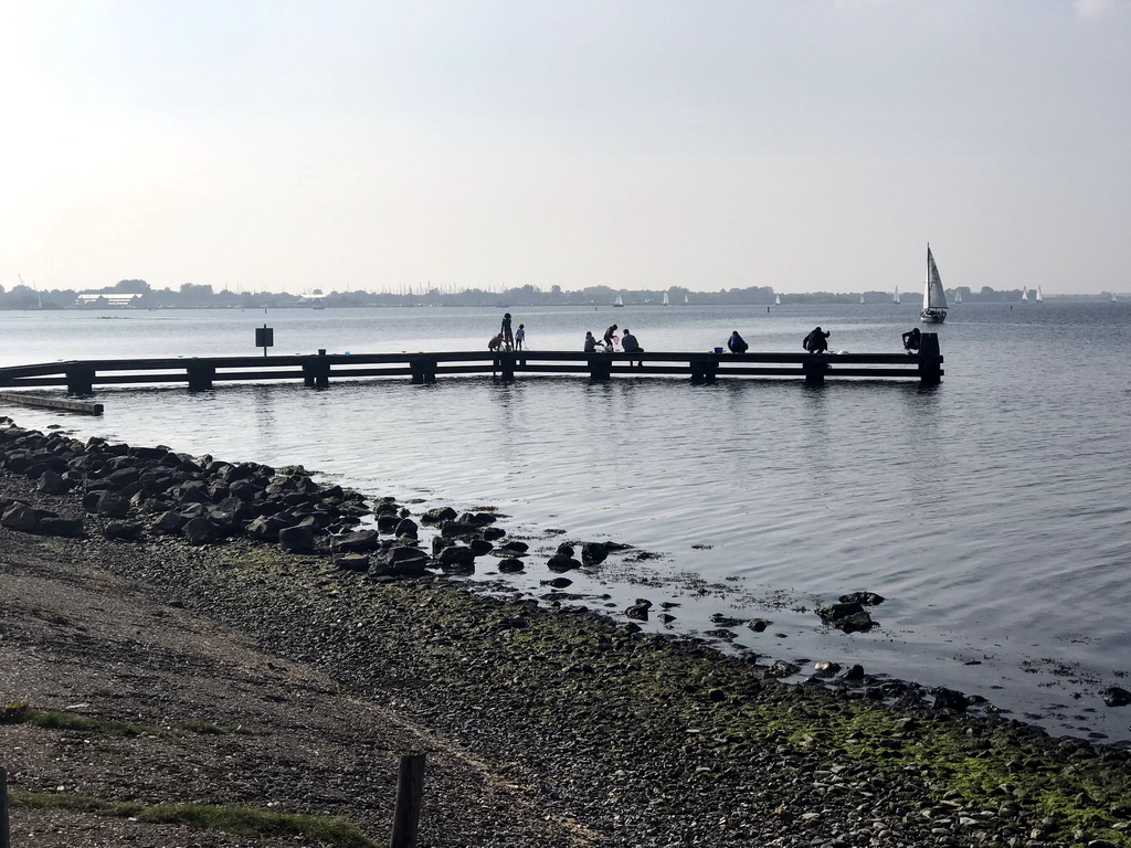 People catching crabs on a pier at the northwest side of the Grevelingendam