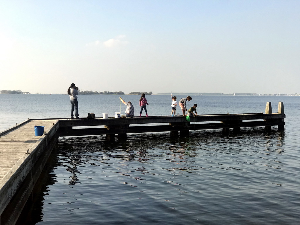 People catching crabs on a pier at the northwest side of the Grevelingendam