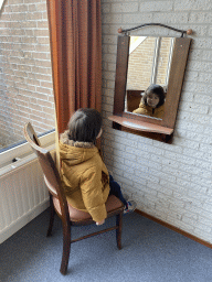 Max looking in a mirror at the first bedroom at the upper floor of our apartment at Holiday Park AquaDelta