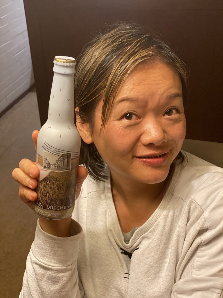 Miaomiao with an Imperial Zeeuws Blond beer in the living room at the ground floor of our apartment at Holiday Park AquaDelta