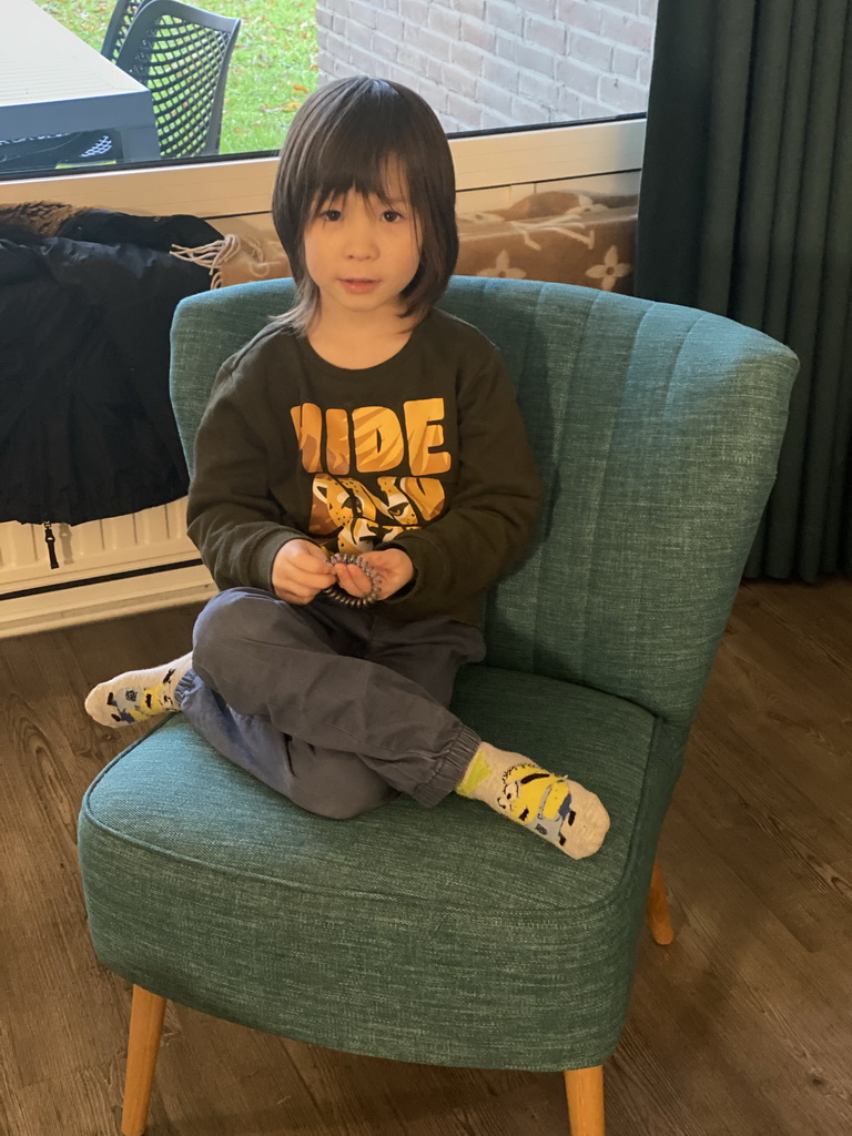 Max sitting on a chair at the living room at the ground floor of our apartment at Holiday Park AquaDelta