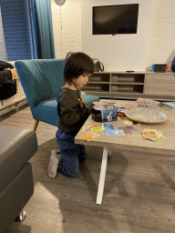 Max playing with Pokémon cards at the living room at the ground floor of our apartment at Holiday Park AquaDelta