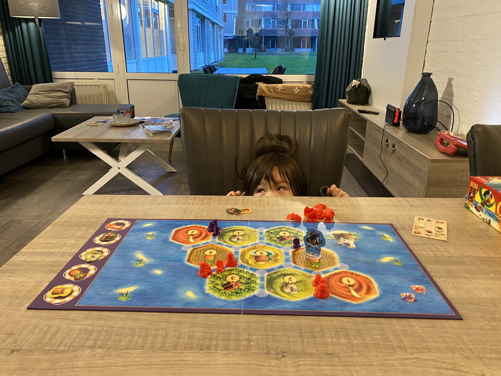 Max playing Catan Junior at the living room at the ground floor of our apartment at Holiday Park AquaDelta