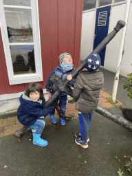 Max and his friends with an anchor in front of the Bru 17 store at the Havenkade street