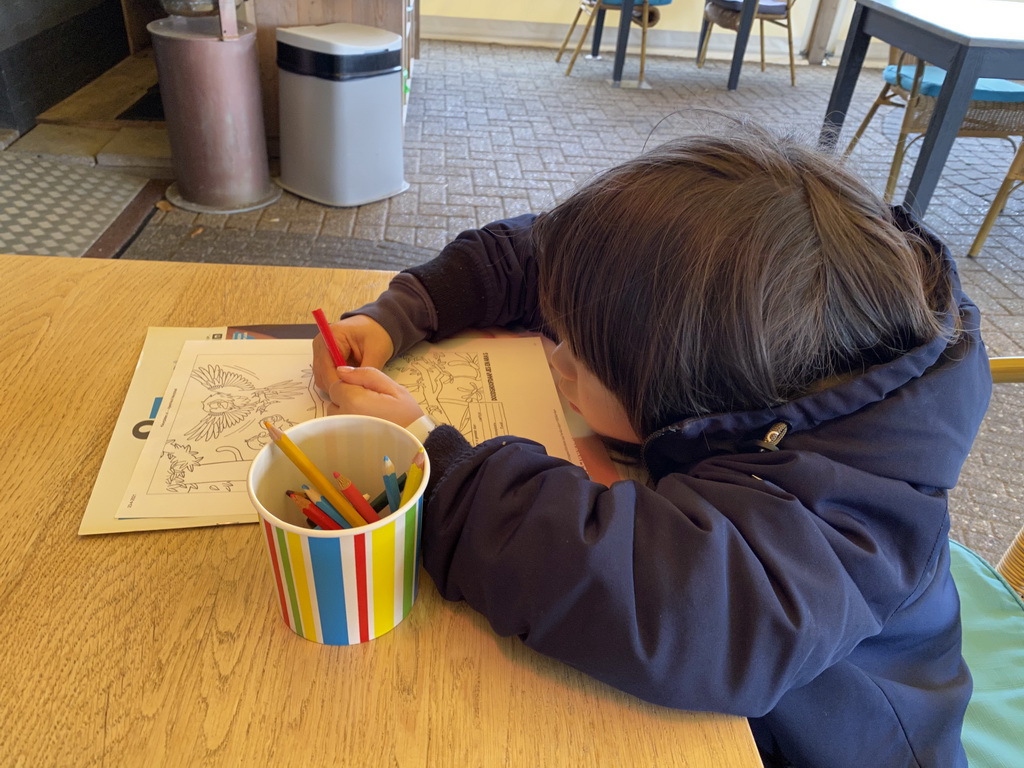 Max with a coloring page at the terrace of the Restaurant De Meeuw