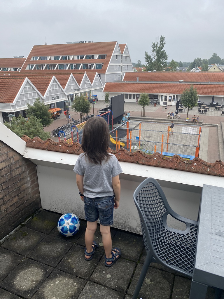 Max on the balcony of the upper floor of our apartment at Holiday Park AquaDelta, with a view on the central square