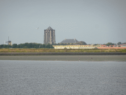 The city center of Zierikzee with a windmill, the Sint-Lievensmonstertoren tower and the Nieuwe Kerk church, viewed from the beach at the Duikplaats Noordbout