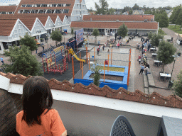 Max on the balcony of the upper floor of our apartment at Holiday Park AquaDelta, with a view on the mascot Koos Konijn at the central square