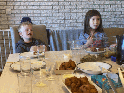 Max and his friend eating kibbeling in the living room at the upper floor of our apartment at Holiday Park AquaDelta