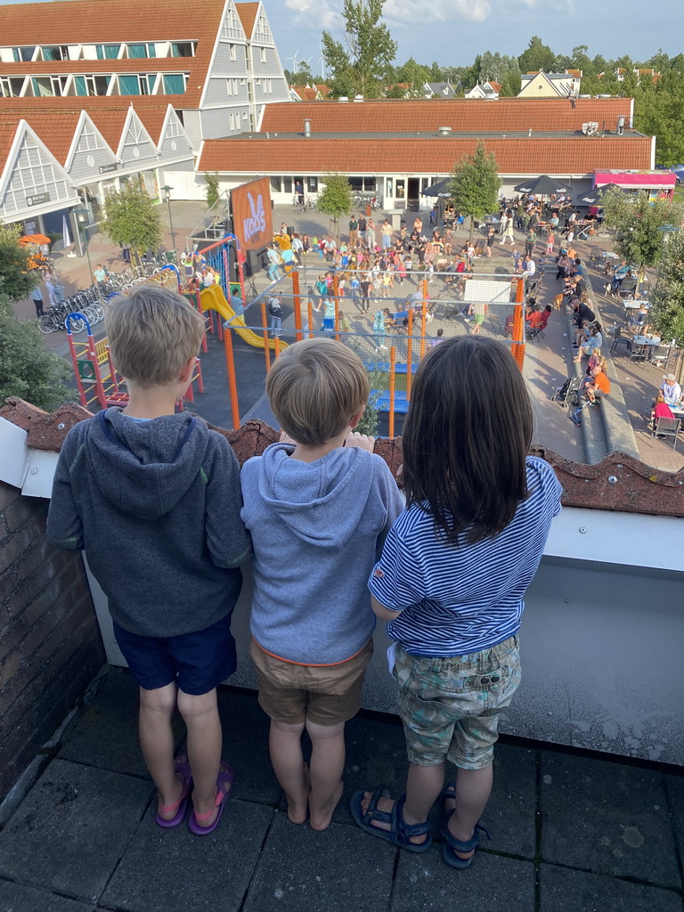 Max and his friends on the balcony of the upper floor of our apartment at Holiday Park AquaDelta, with a view on the mascot Koos Konijn at the central square