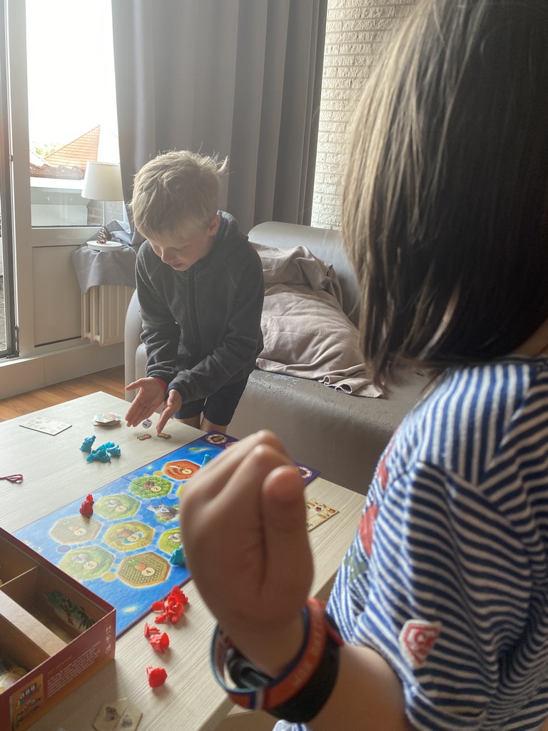 Max and his friend playing Catan Junior in the living room at the upper floor of our apartment at Holiday Park AquaDelta