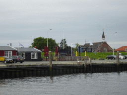 The Bru 17 restaurant and the Gereformeerde Kerk Bruinisse church, viewed from the Seal Safari boat in the Harbour of Bruinisse