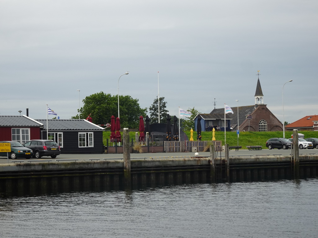 The Bru 17 restaurant and the Gereformeerde Kerk Bruinisse church, viewed from the Seal Safari boat in the Harbour of Bruinisse