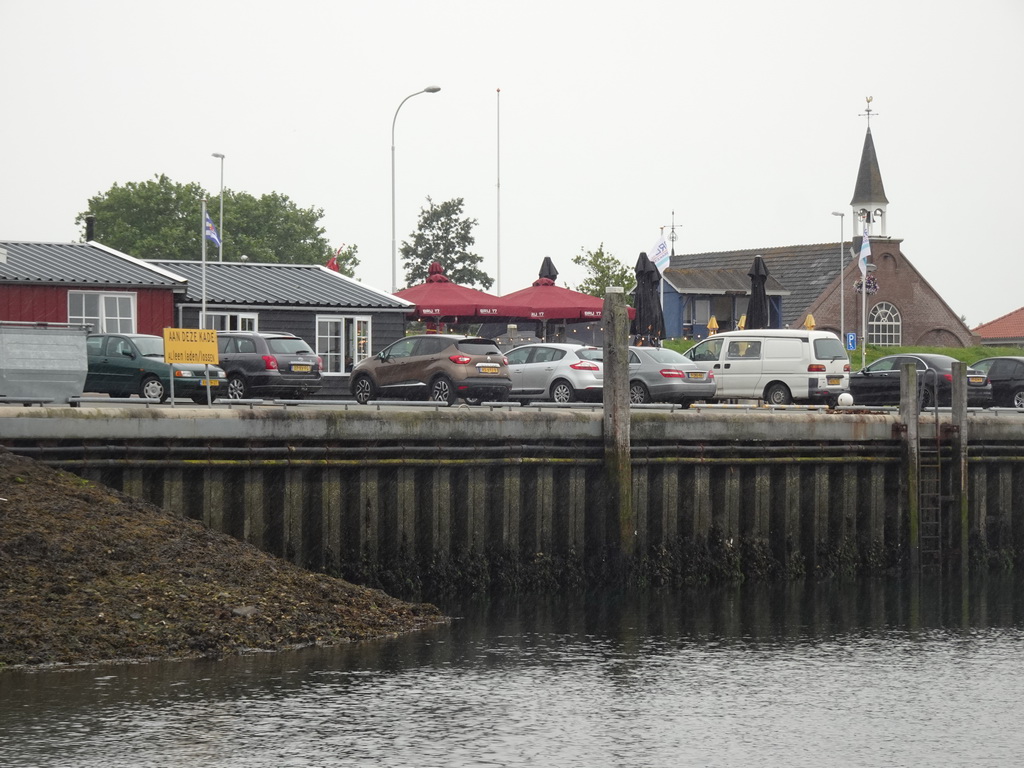 The Bru 17 restaurant and the Gereformeerde Kerk Bruinisse church, viewed from the Seal Safari boat in the Harbour of Bruinisse