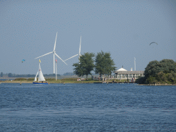 Boat, windmills and the PUURR by Rich restaurant at the north side of the Grevelingendam
