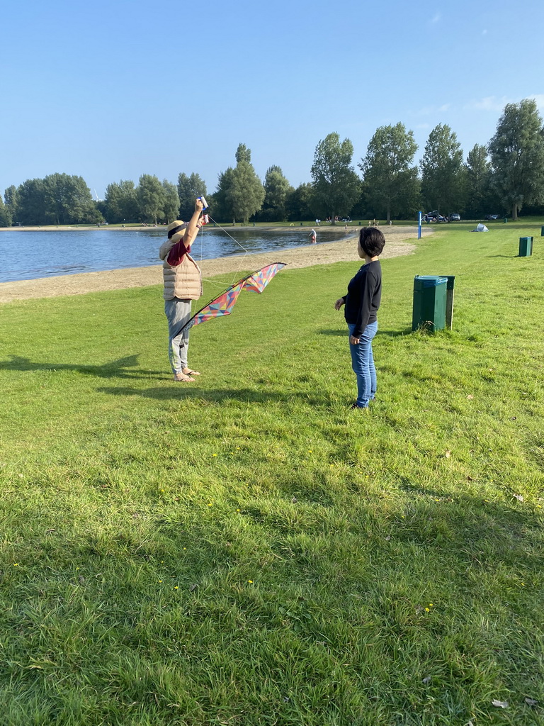 Miaomiao and our friend flying a kite on a beach at the north side of the Grevelingendam