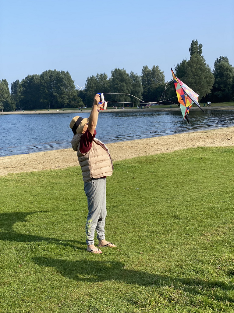 Miaomiao flying a kite on a beach at the north side of the Grevelingendam