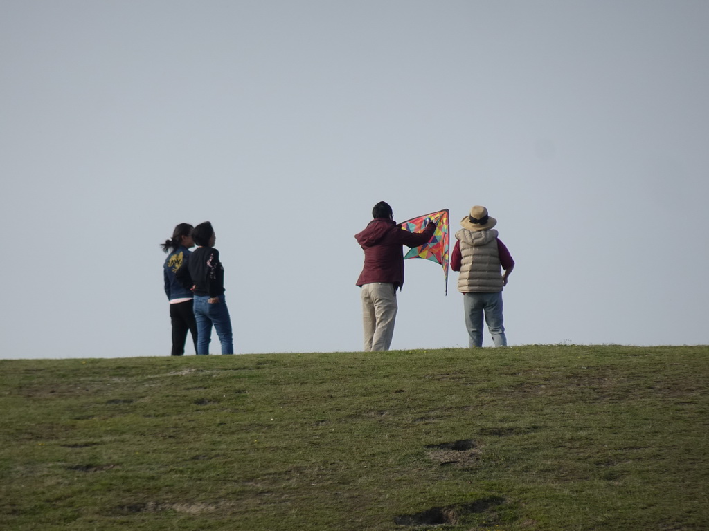 Miaomiao and our friends flying a kite on a hill at the north side of the Grevelingendam