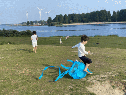 Max and our friends flying kites on a beach at the north side of the Grevelingendam, with a view on the PUURR by Rich restaurant