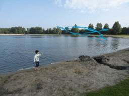 Max flying a kite on a beach at the north side of the Grevelingendam