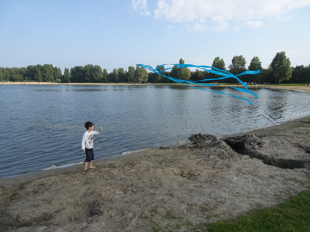 Max flying a kite on a beach at the north side of the Grevelingendam