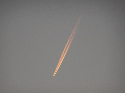 Airplane above a beach at the north side of the Grevelingendam, at sunset