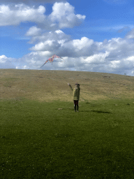 Miaomiao flying a kite on a hill at the north side of the Grevelingendam