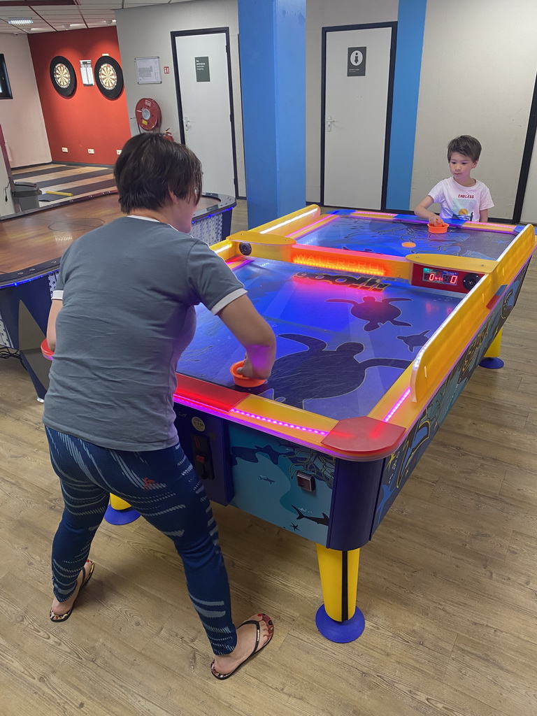 Miaomiao and Max playing air hockey at the gaming room of Holiday Park AquaDelta