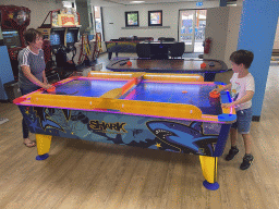 Miaomiao and Max playing air hockey at the gaming room of Holiday Park AquaDelta