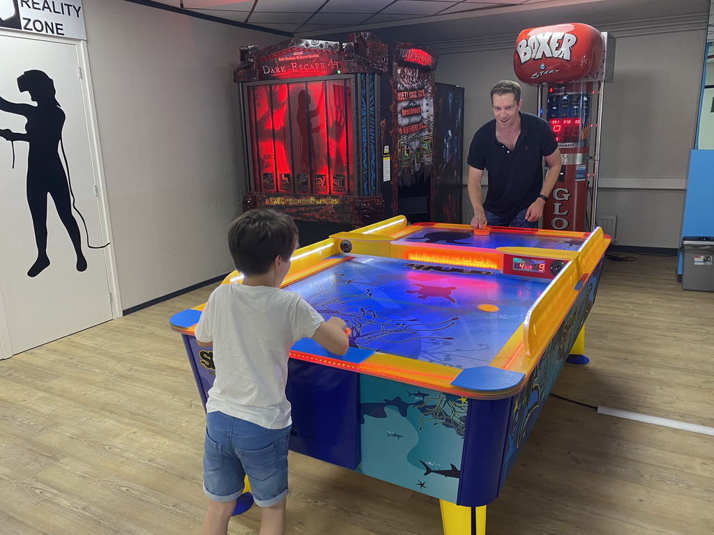 Tim and Max playing air hockey at the gaming room of Holiday Park AquaDelta