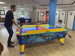 Tim and Max playing air hockey at the gaming room of Holiday Park AquaDelta