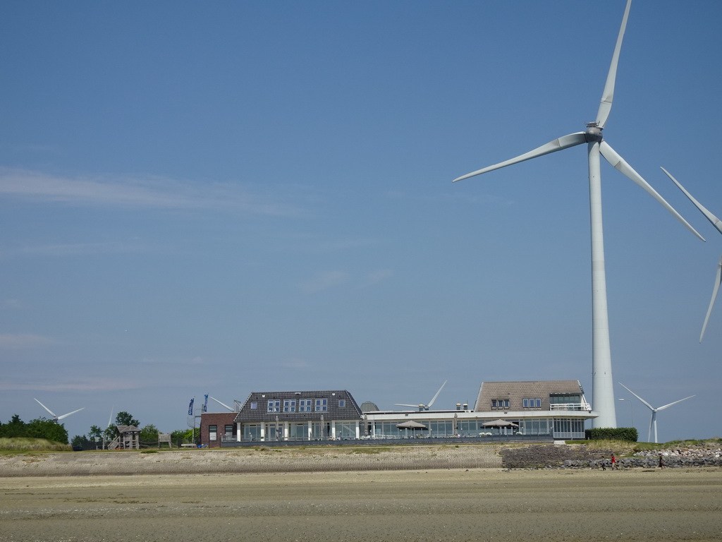 Restaurant Grevelingen and windmills at the southeast side of the Grevelingendam, viewed from the beach at the south side