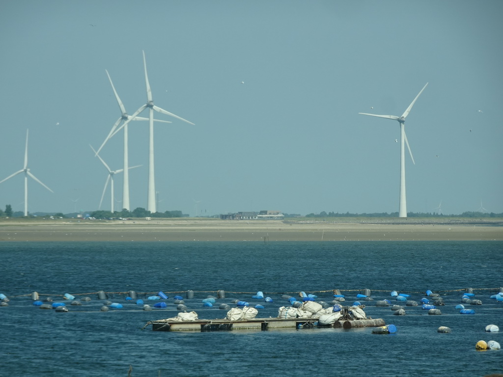 The beach, Restaurant Grevelingen and windmills at the south side of the Grevelingendam and the Krammer lake, viewed from the car on the Grevelingensluis street