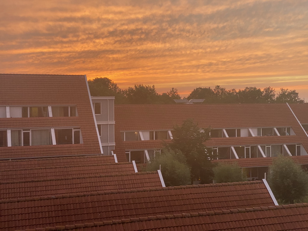 Sunset over the roofs of buildings at Holiday Park AquaDelta, viewed from the balcony of our apartment