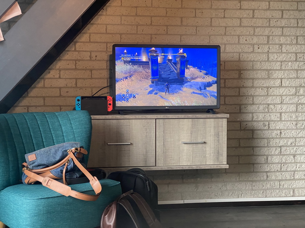 TV screen with the Nintendo Switch game `Immortals Fenyx Rising` in the living room at the lower floor of our apartment at Holiday Park AquaDelta